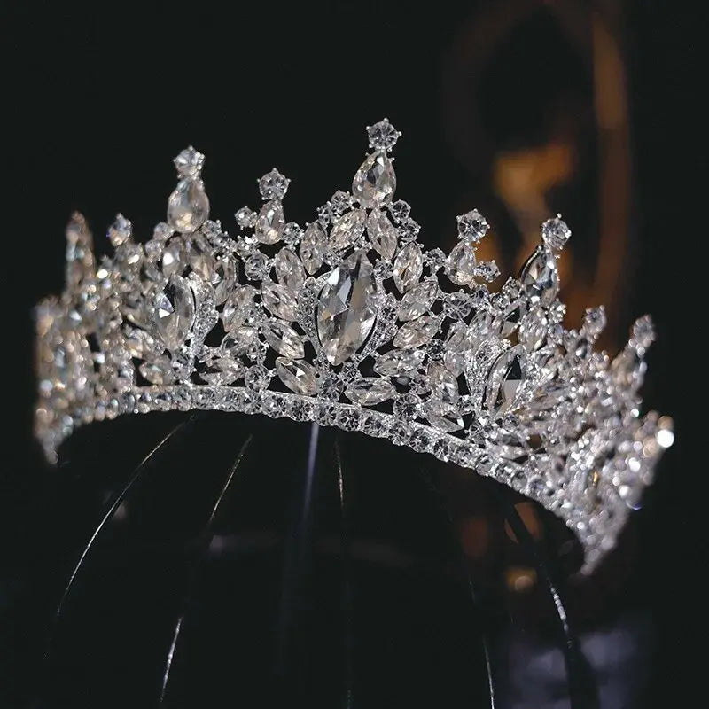 Side angle view highlighting the intricate crystal leaf patterns and brilliant rhinestone cluster detailing of the bridal headband crown.
