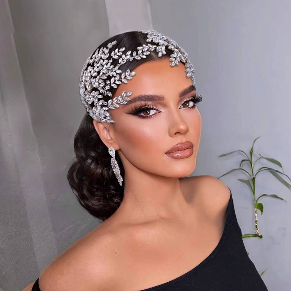 Model wearing a luxury rhinestone bridal tiara headband with leaf design for wedding hair