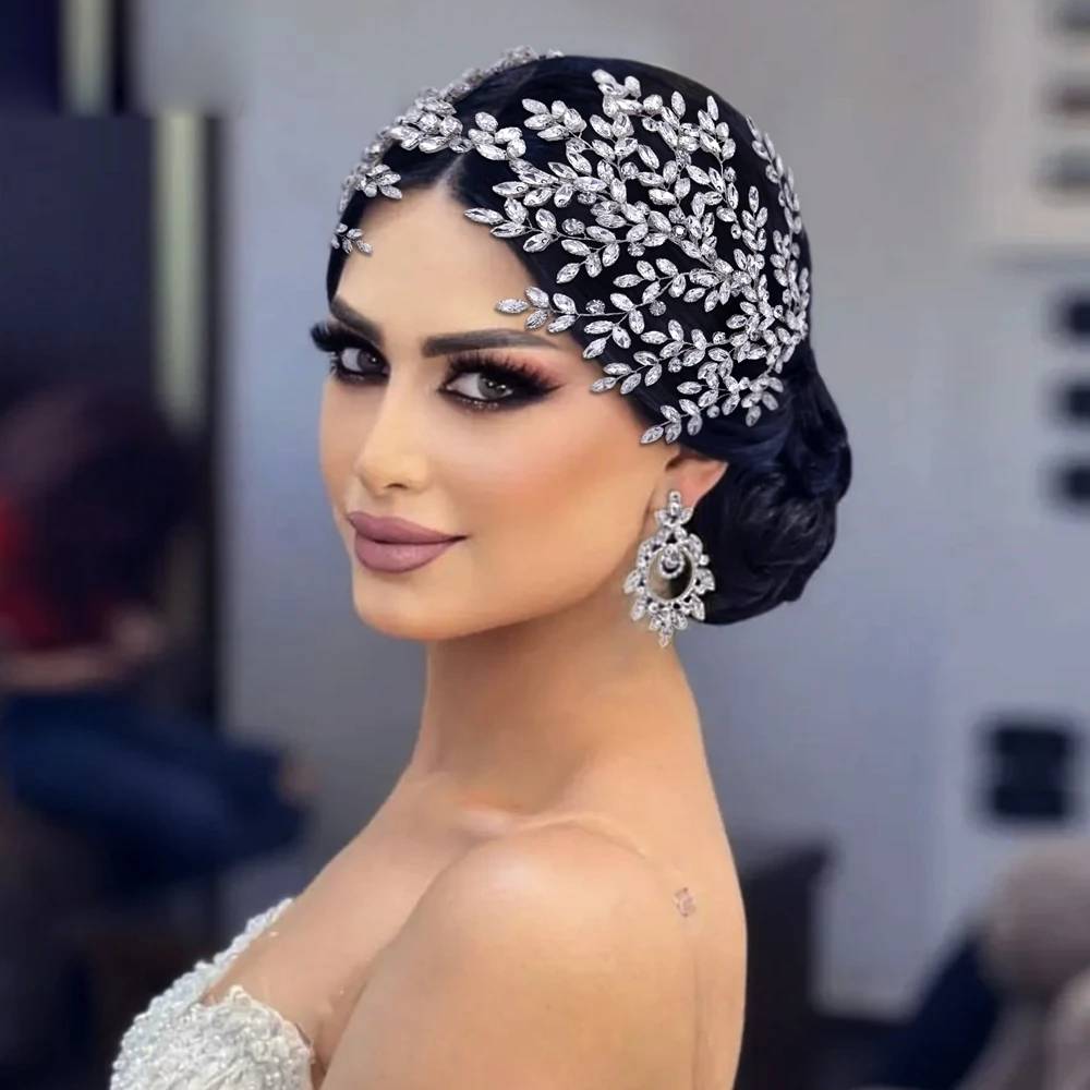 Close-up of a bride with elegant bridal updo hairstyle wearing a crystal rhinestone leaf tiara