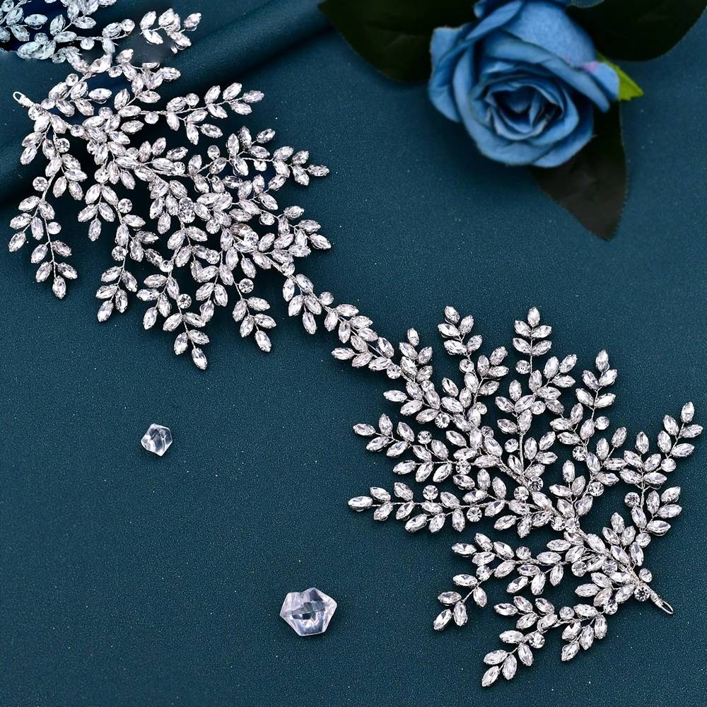Flat lay view of sparkling rhinestone leaf bridal hair accessory.