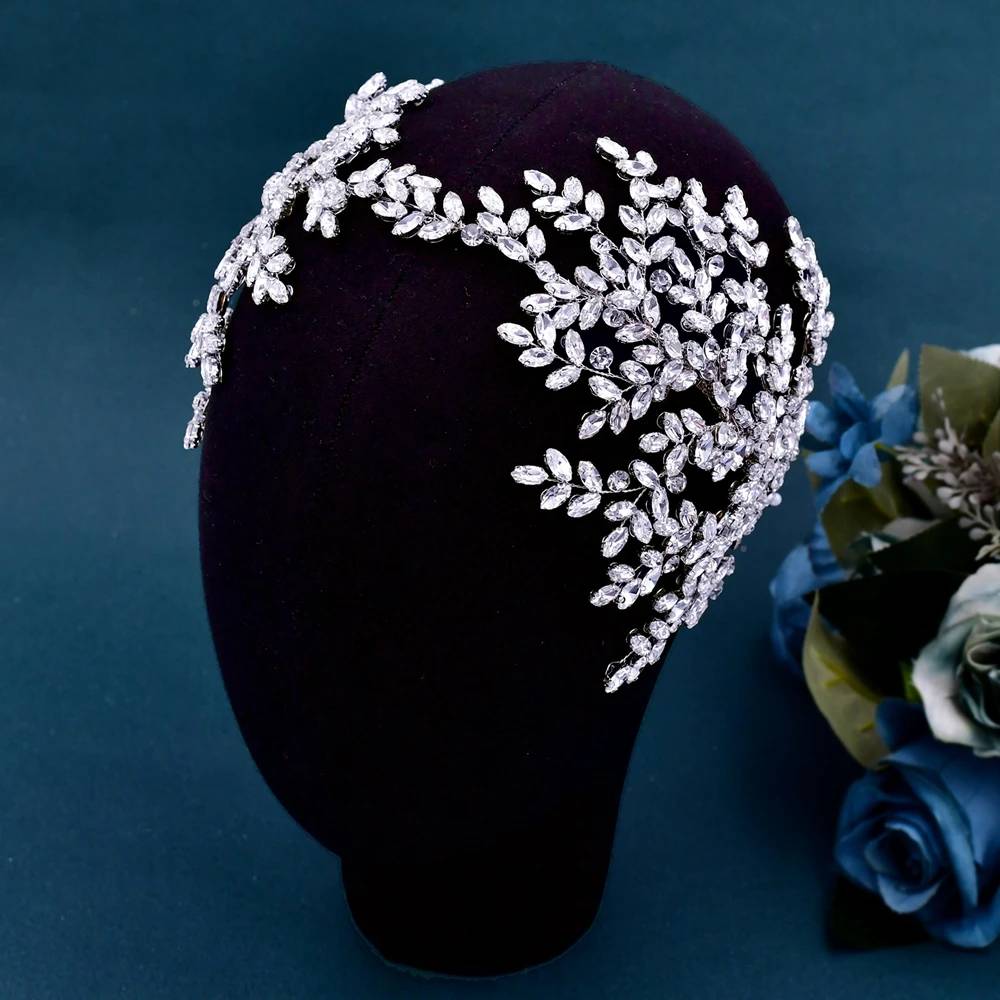 Close-up of elegant crystal leaf bridal tiara headband on a black mannequin head for wedding styling