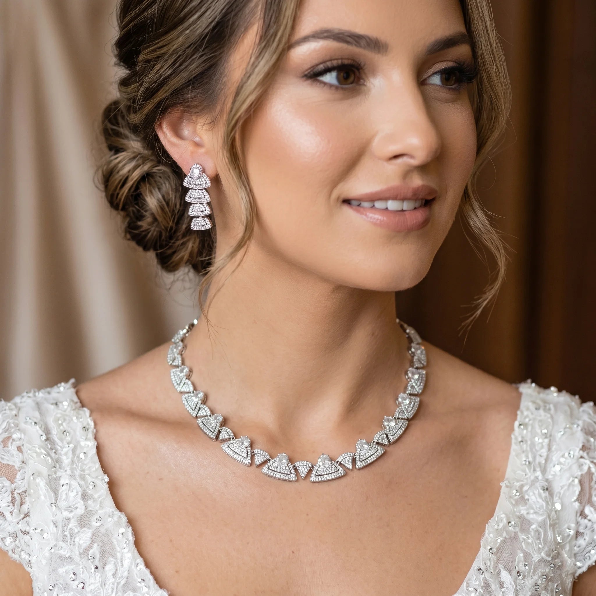 Model wearing a luxury round choker necklace and matching tiered geometric earrings for a bridal wedding look.
