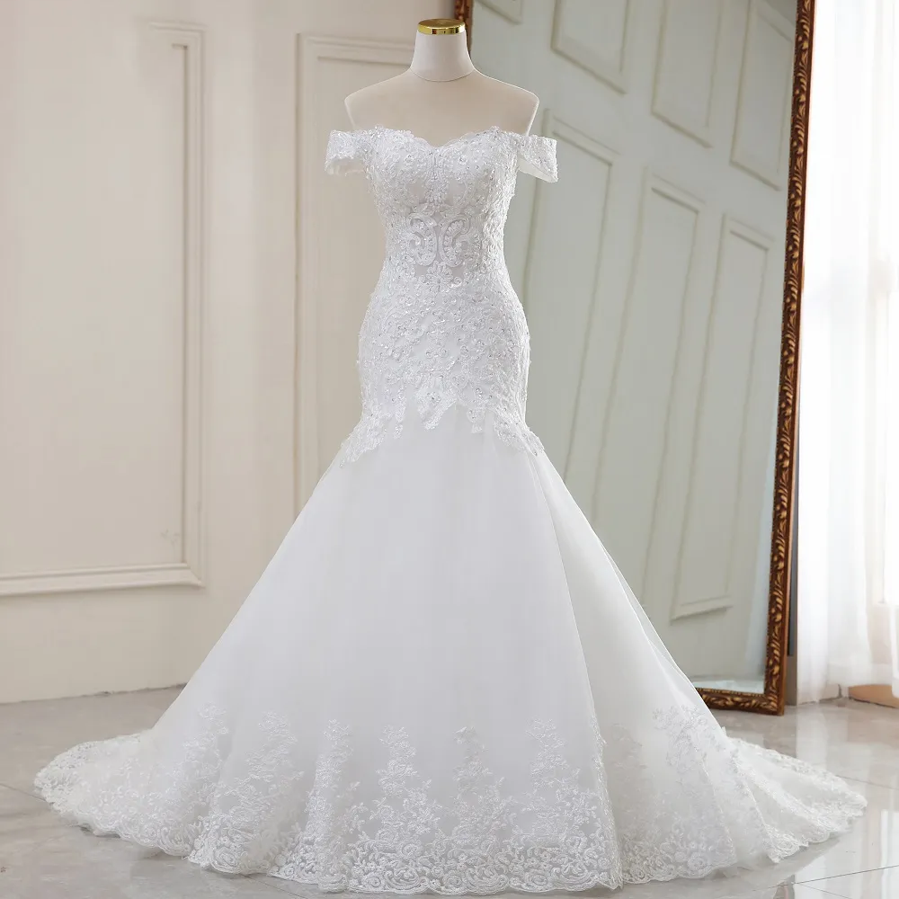 Mannequin display showcasing the front silhouette of a luxury off-the-shoulder mermaid wedding dress with ornate lace appliques.