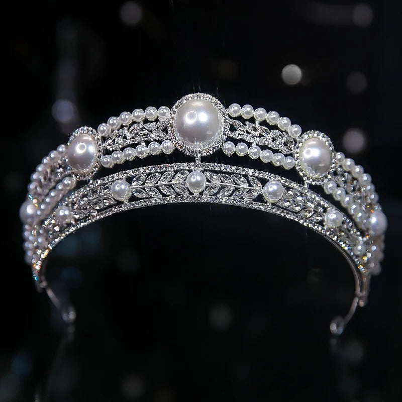 A glamorous double-banded silver bridal headband tiara adorned with large round pearls and leaf-patterned crystal accents.