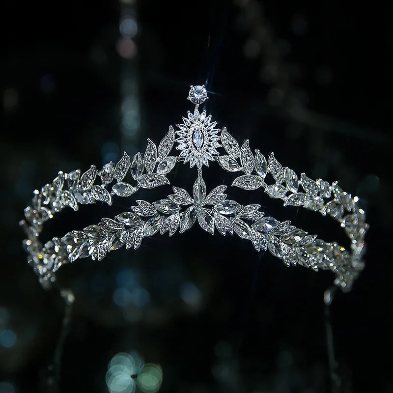 A modern double-banded silver bridal tiara adorned with marquise crystals in leaf patterns and a starburst center peak.
