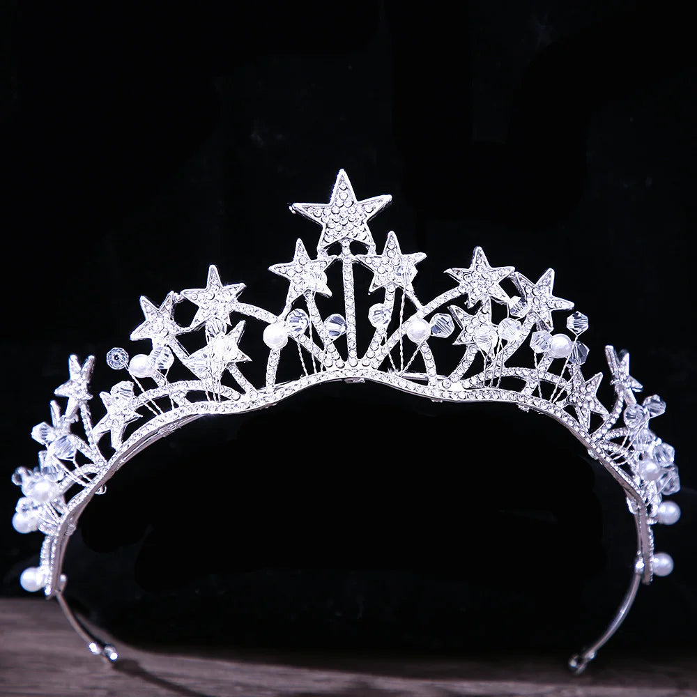 A whimsical silver celestial bridal headpiece designed with multi-pointed crystal stars and delicate pearls.