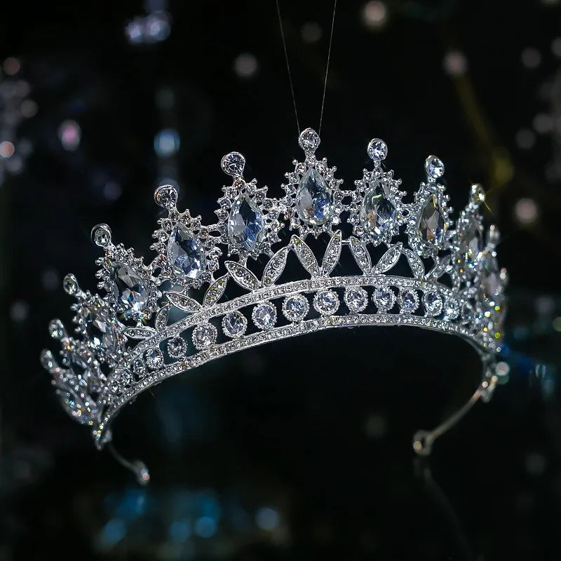 A classic silver-plated bridal diadem crown highlighting large pear-shaped crystals and an open-work rhinestone base.