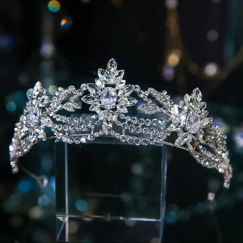 An elegant silver crystal tiara designed with marquise-cut rhinestones shaped into delicate floral and vine motifs.
