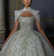 Luxury sleeveless princess wedding ball gown featuring a heavily crystal-beaded sweetheart bodice, paired with a matching high-neck keyhole bridal bolero jacket.