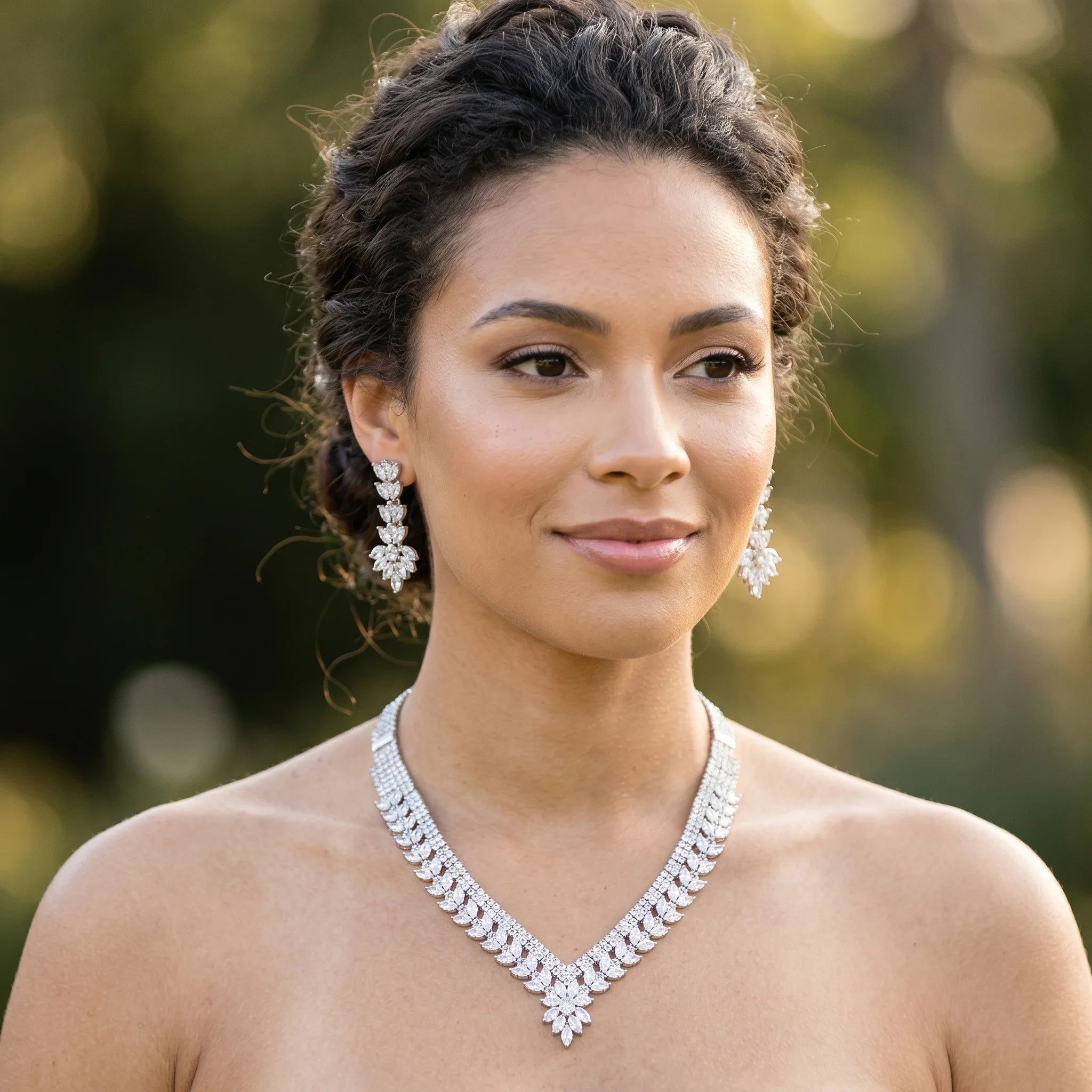 Model wearing a luxury water drop shaped cubic zirconia V-neck collar necklace and matching chandelier drop earrings.