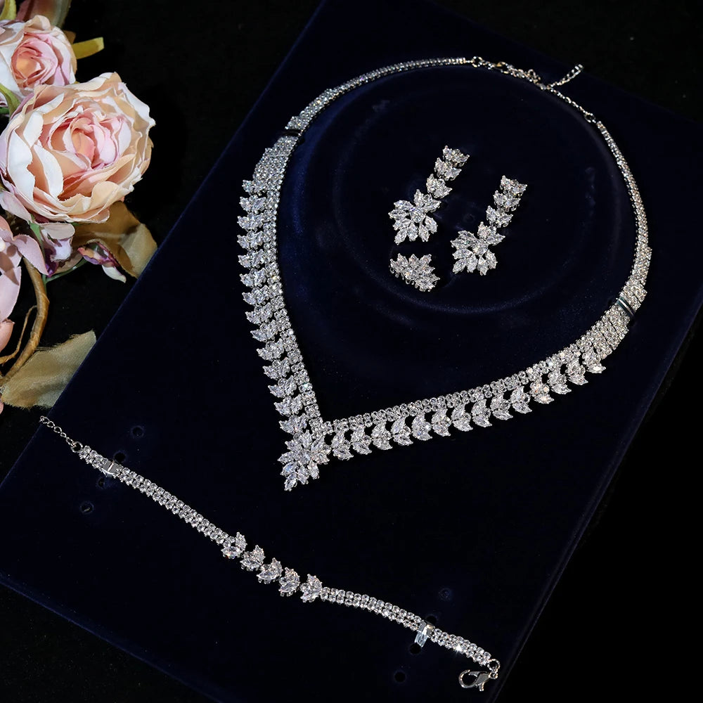 Symmetrical overhead shot of a white gold plated cubic zirconia bridal collar necklace and double-row leaf bracelet set.