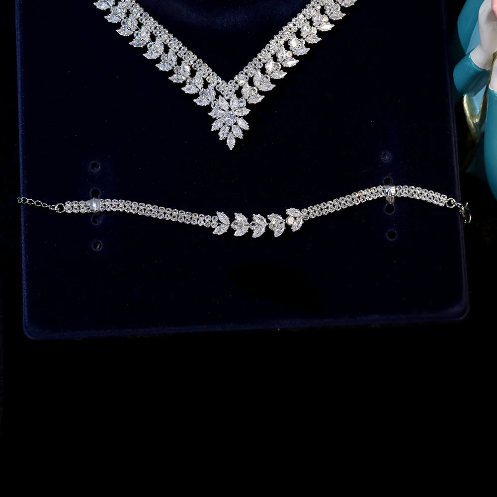 Detailed close-up macro view of a silver double-row cubic zirconia tennis bracelet with a central marquise crystal leaf pattern.