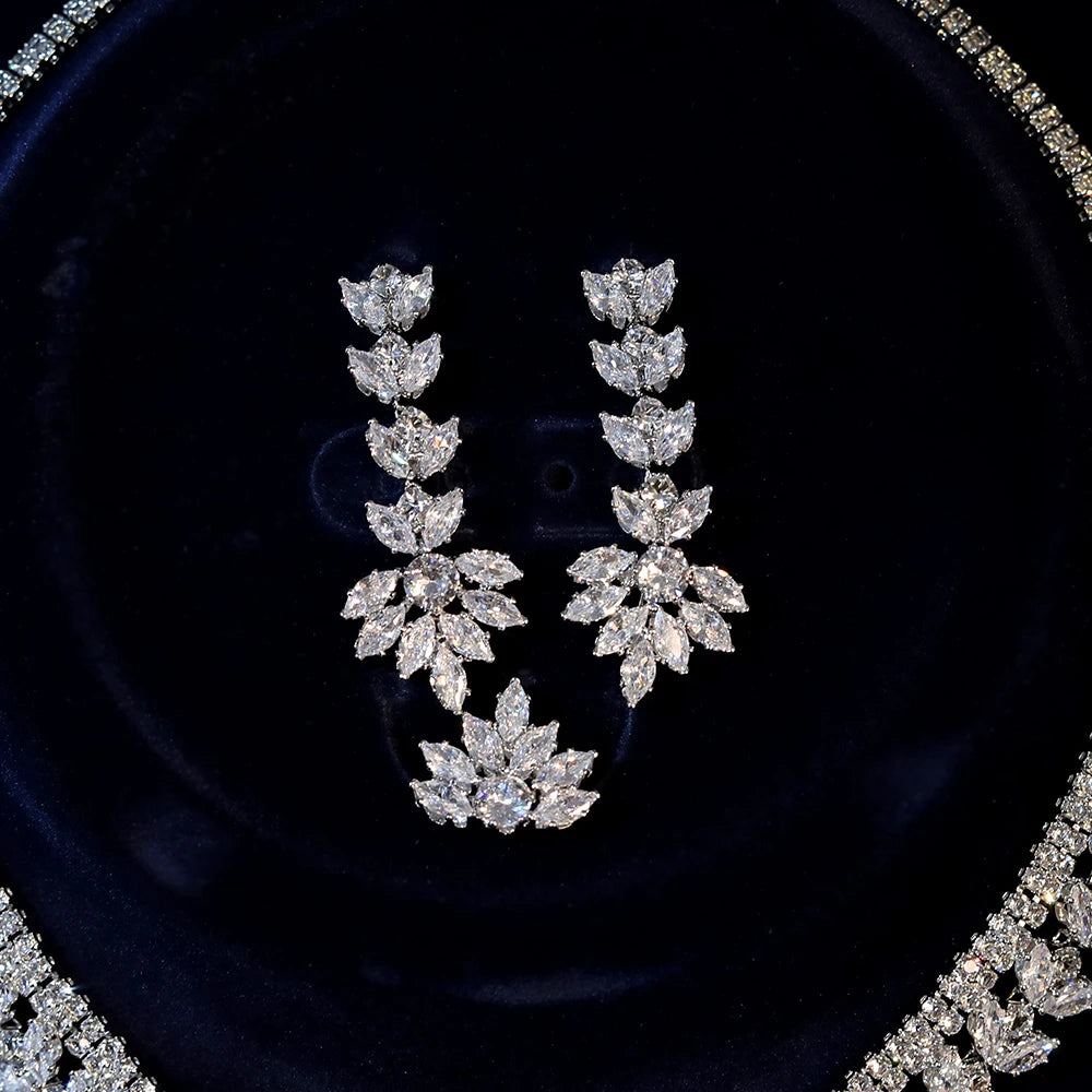 Close-up macro shot of intricate marquise-cut crystal chandelier water drop earrings from a luxury bridal wedding collection.
