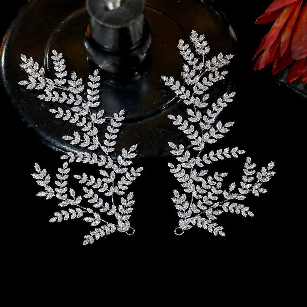 Direct overhead shot of the silver bridal hair vine pin variants, highlighting the brilliant pave stone settings against a stark black background.