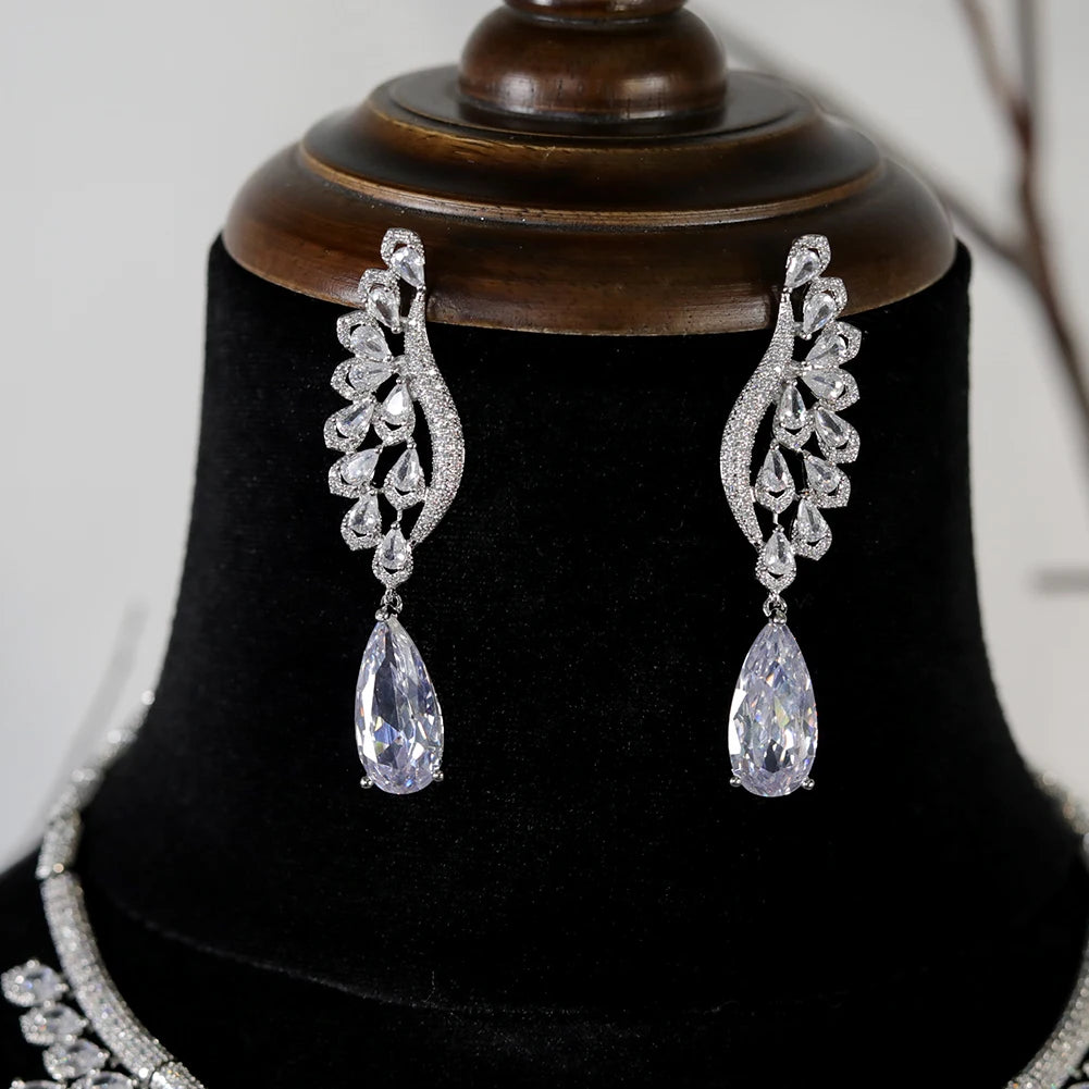 Close-up view of elegant cubic zirconia feather-wing dropdown earrings from a luxury bridal jewelry set.