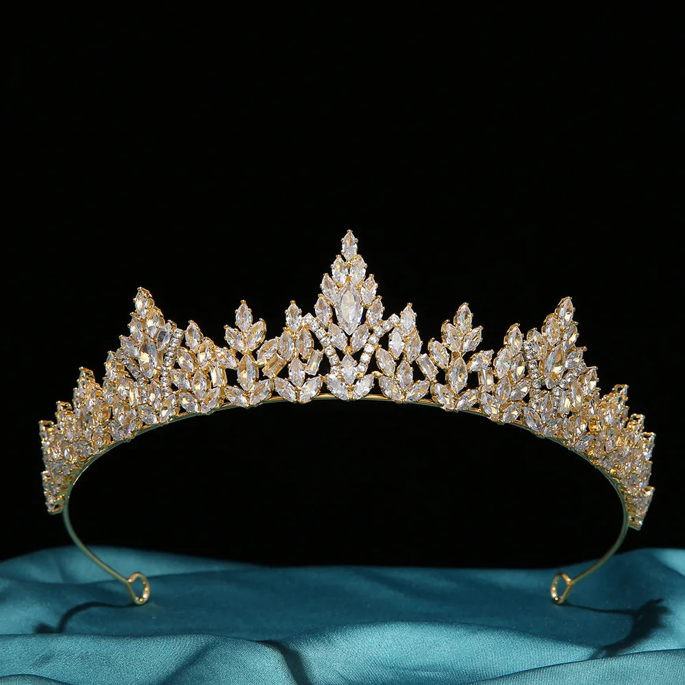 Front view of a gold wedding and party headpiece crown featuring marquise-cut zircon crystals on a dark backdrop.