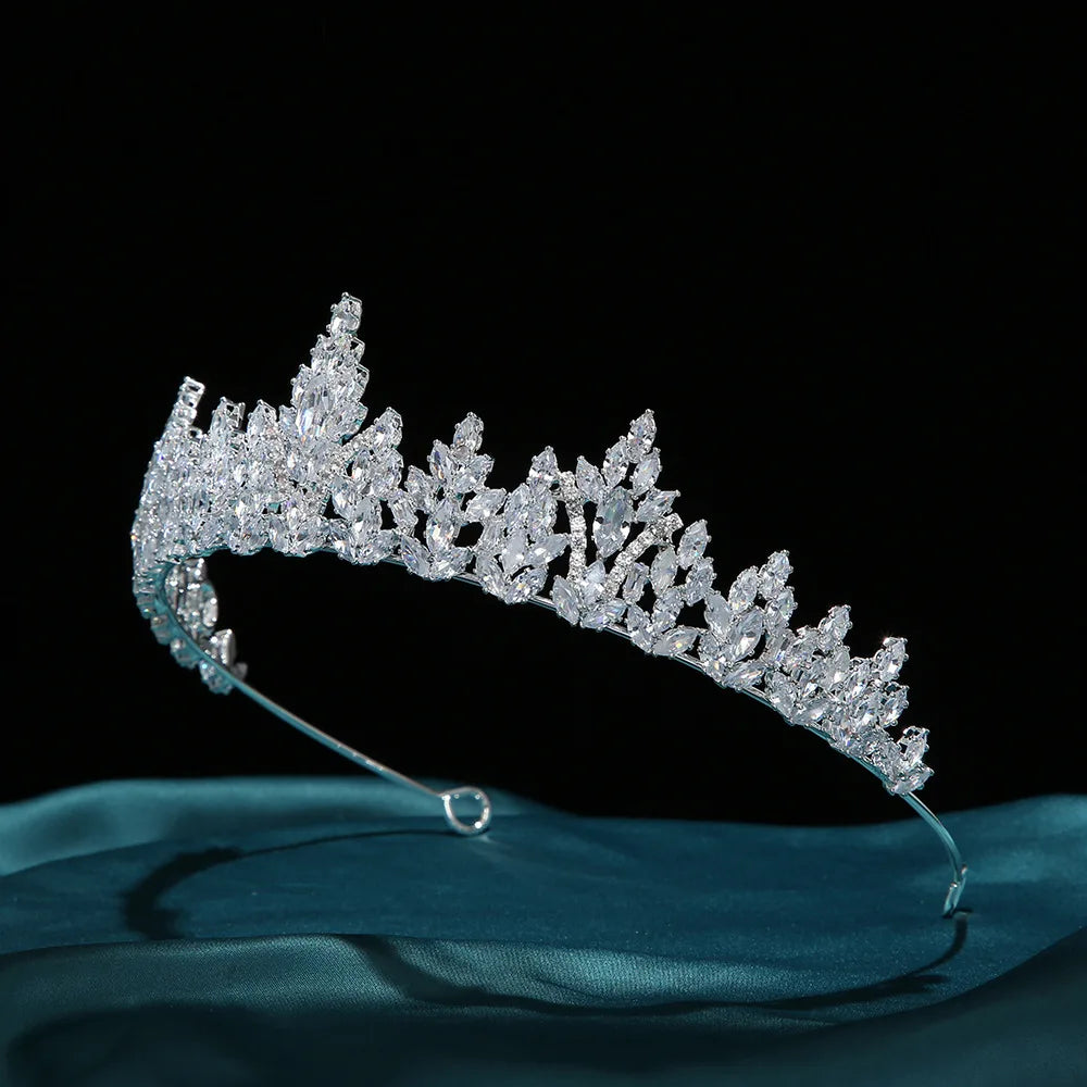 Side angle view of a silver-tone luxury bridal tiara crown adorned with brilliant zircon crystals.