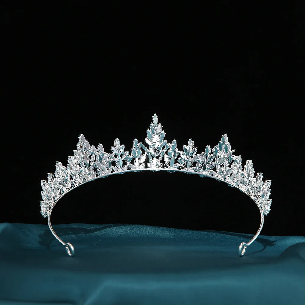 A glittering silver zircon tiara headpiece for women, cleanly shot against a solid black background.