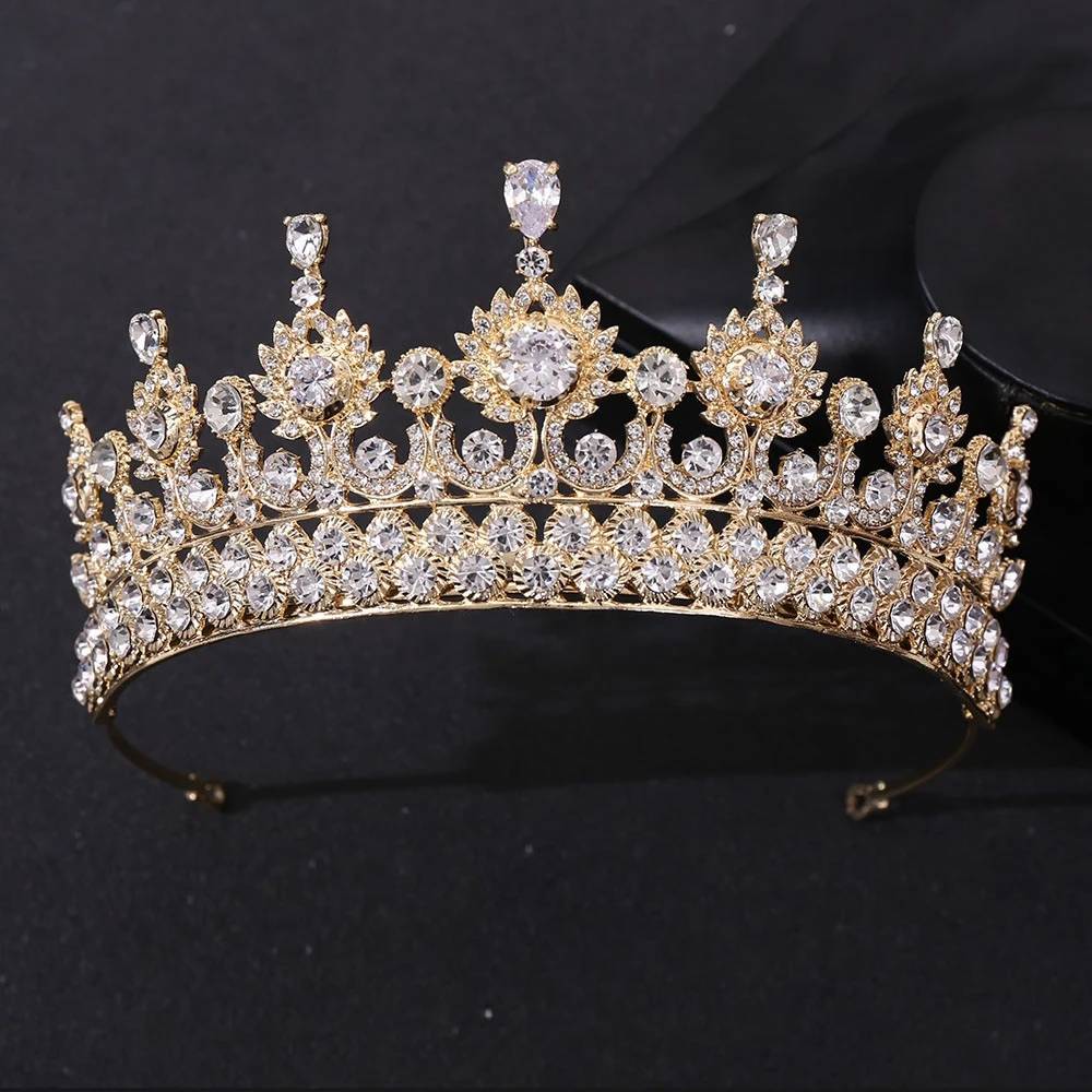 Front view of a luxury gold-plated zircon crystal bridal tiara crown featuring a prominent teardrop crystal center peak on a dark background.