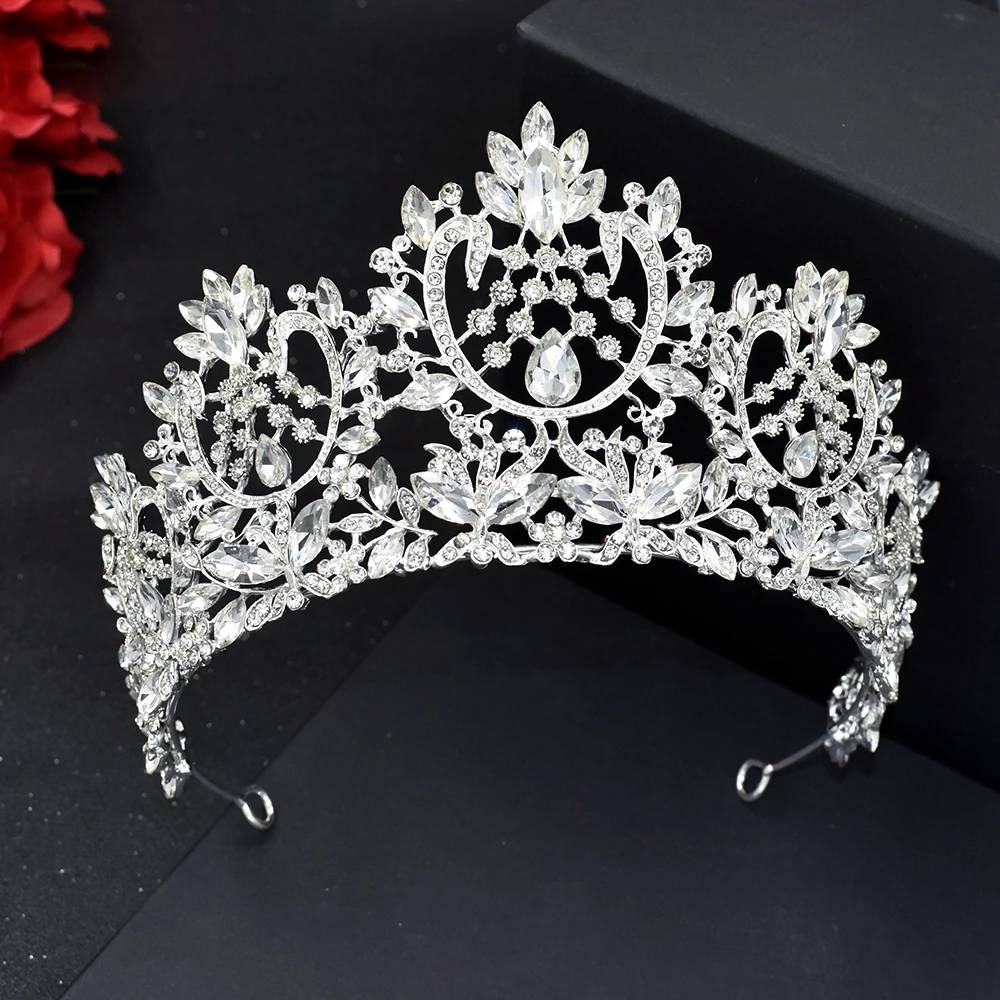 A majestic silver zircon crystal pageant headband crown with intricate open-pattern scrollwork and floral rhinestone details.