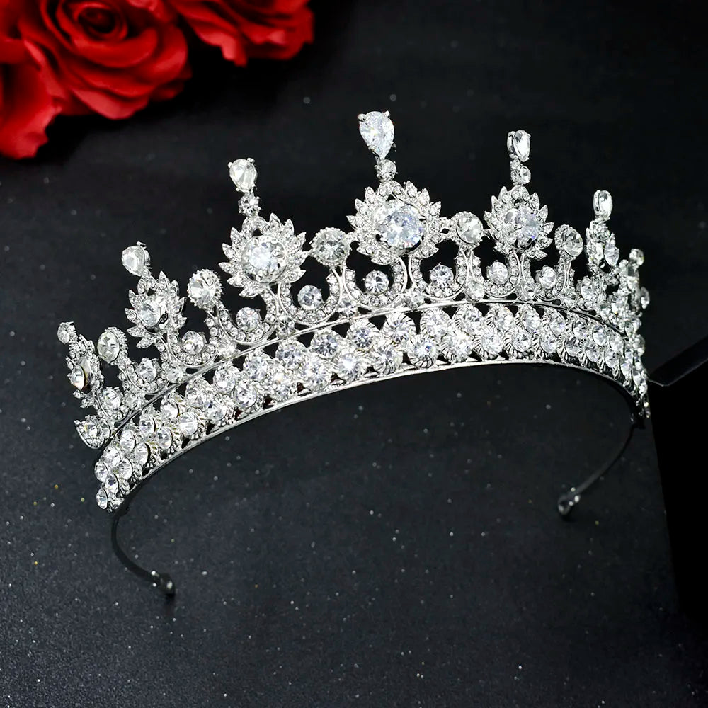 Elegant silver zircon crystal wedding headband crown featuring classic spires and round-cut gemstones against a dark background with red roses.
