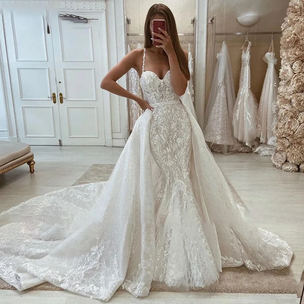 A 2-in-1 Brazilian mermaid wedding dress featuring a removable tulle skirt, beaded bodice, and exquisite lace details for versatile styling.