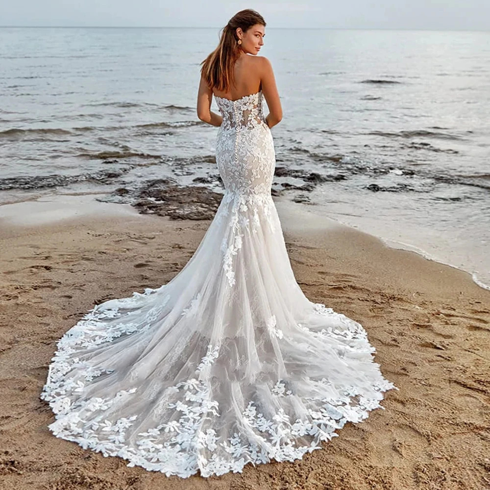 Stately pure white mermaid wedding gown featuring a structured lace sweetheart top with draped off-the-shoulder sleeves and a flared trumpet skirt.