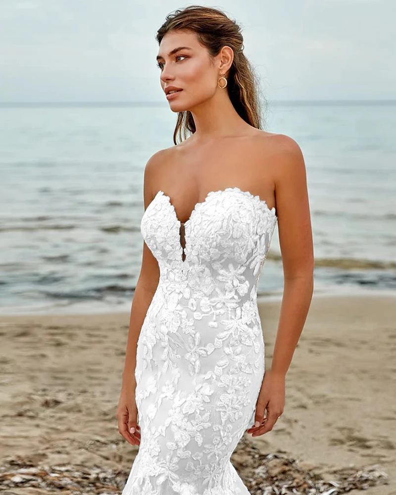 Luxury champagne underlay mermaid bridal gown with a deep plunge sweetheart neckline lining and an elongated sheer floral lace trumpet train.