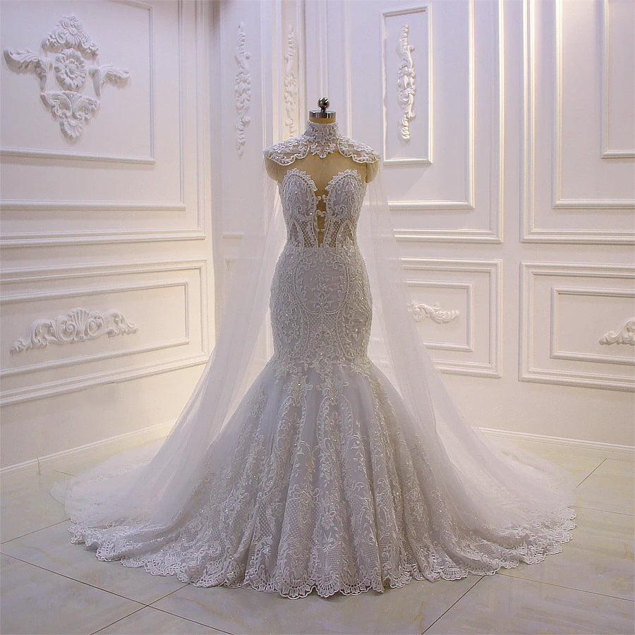 Full-length view of the mermaid wedding dress on a mannequin, highlighting the fitted bodice, delicate lace details, and a floor-sweeping detachable cape.
