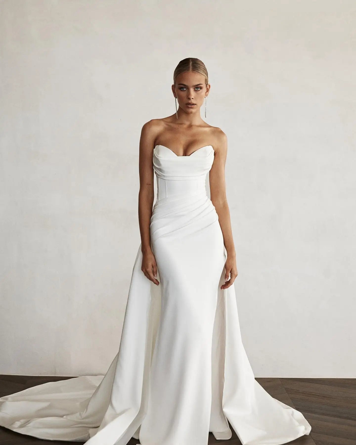 Stylish modern mermaid bridal gown with a sophisticated sweetheart bodice and clean lines, perfect for a chic bridal look.