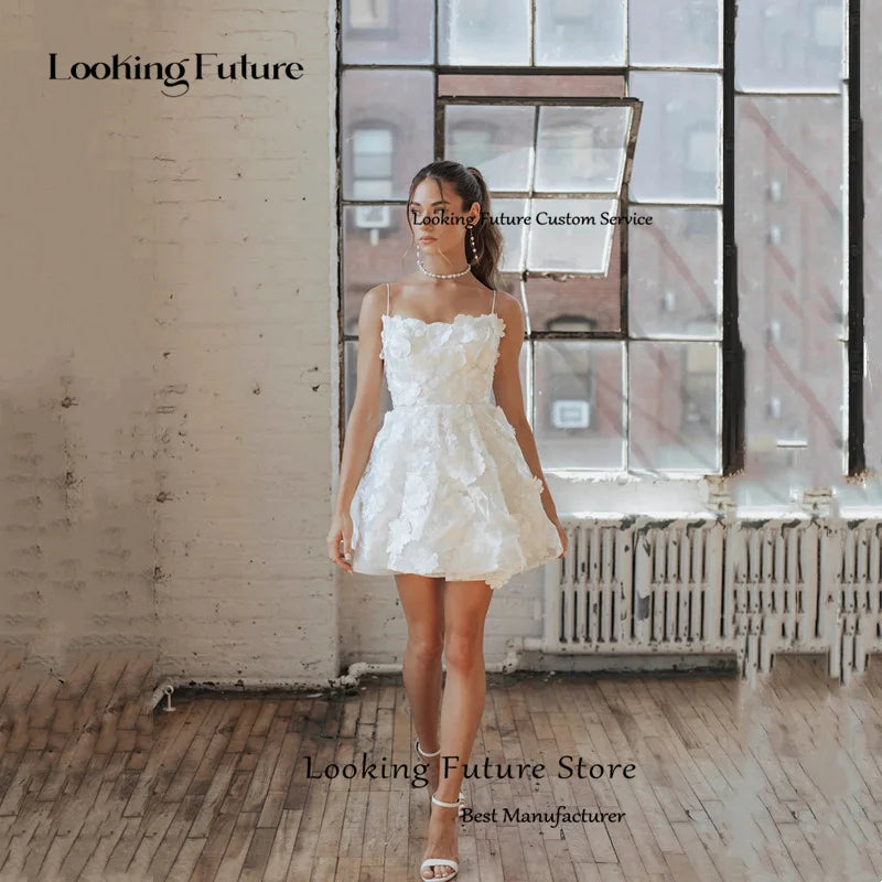 Chic pure white short wedding reception dress with thin straps, a structured waistline, and a playful flared multi-layer mini skirt perfect for a civil ceremony.