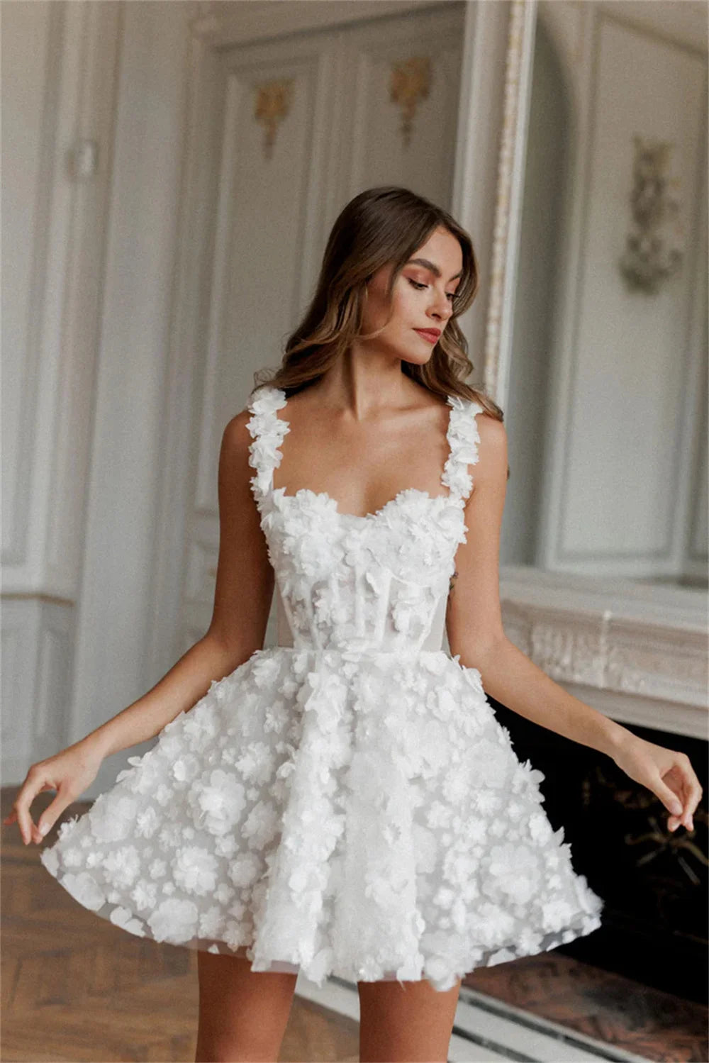 Chic short sleeveless A-line wedding reception dress with miniature 3D blossom embellishments and a voluminous structured net underskirt.