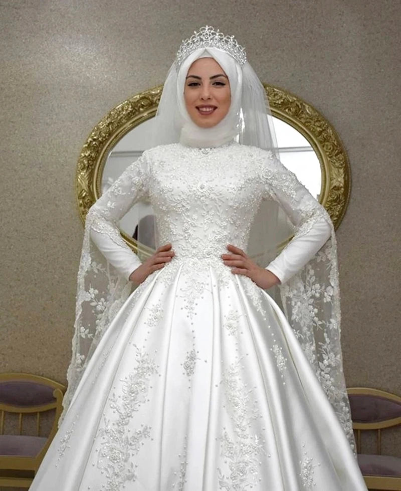 Close-up front view of a modest Islamic wedding dress with long sleeves and delicate lace appliques, ideal for an elegant bridal look.