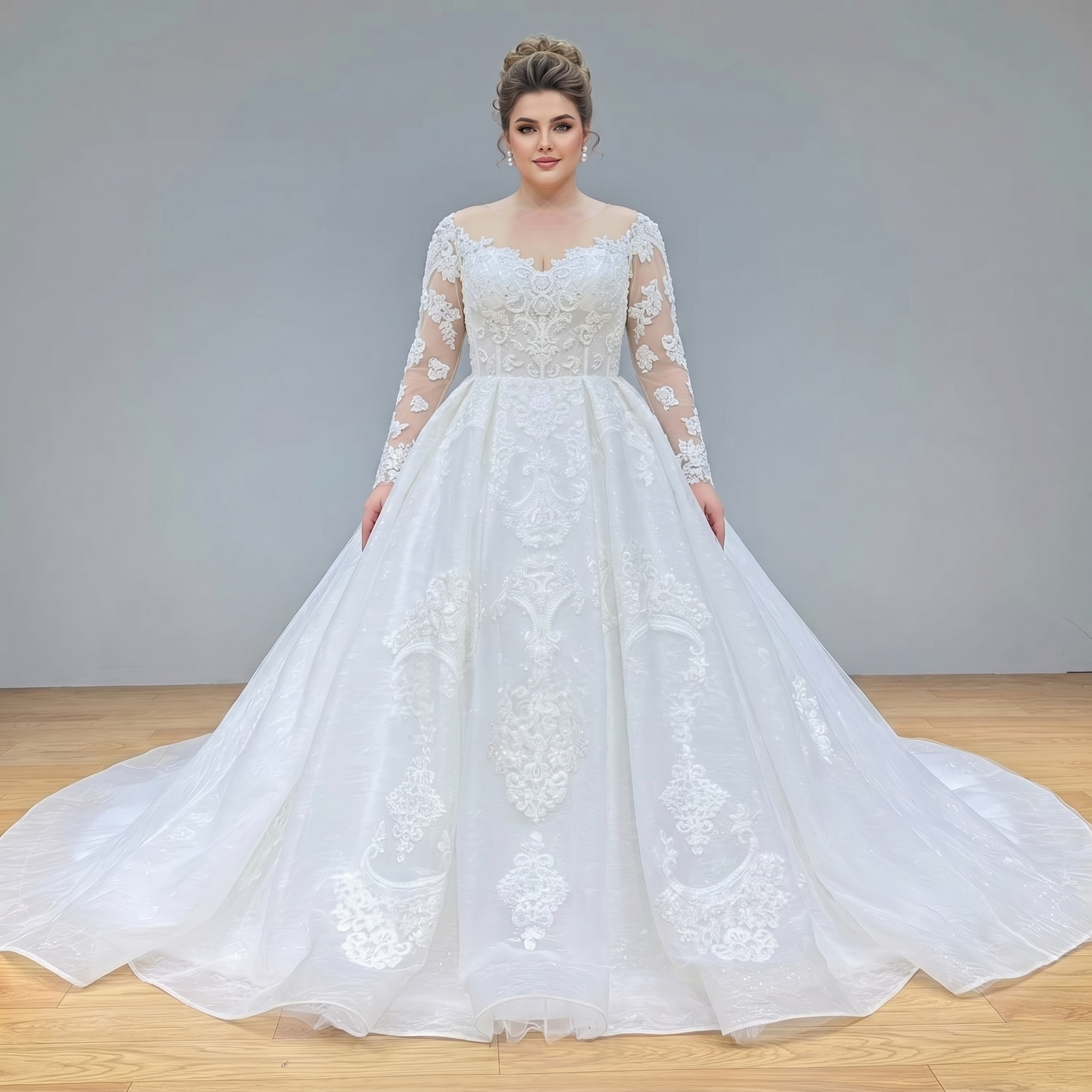 Front view of a plus-size bridal model wearing a regal long sleeve ball gown wedding dress with a beaded lace bodice and a sheer illusion neckline.