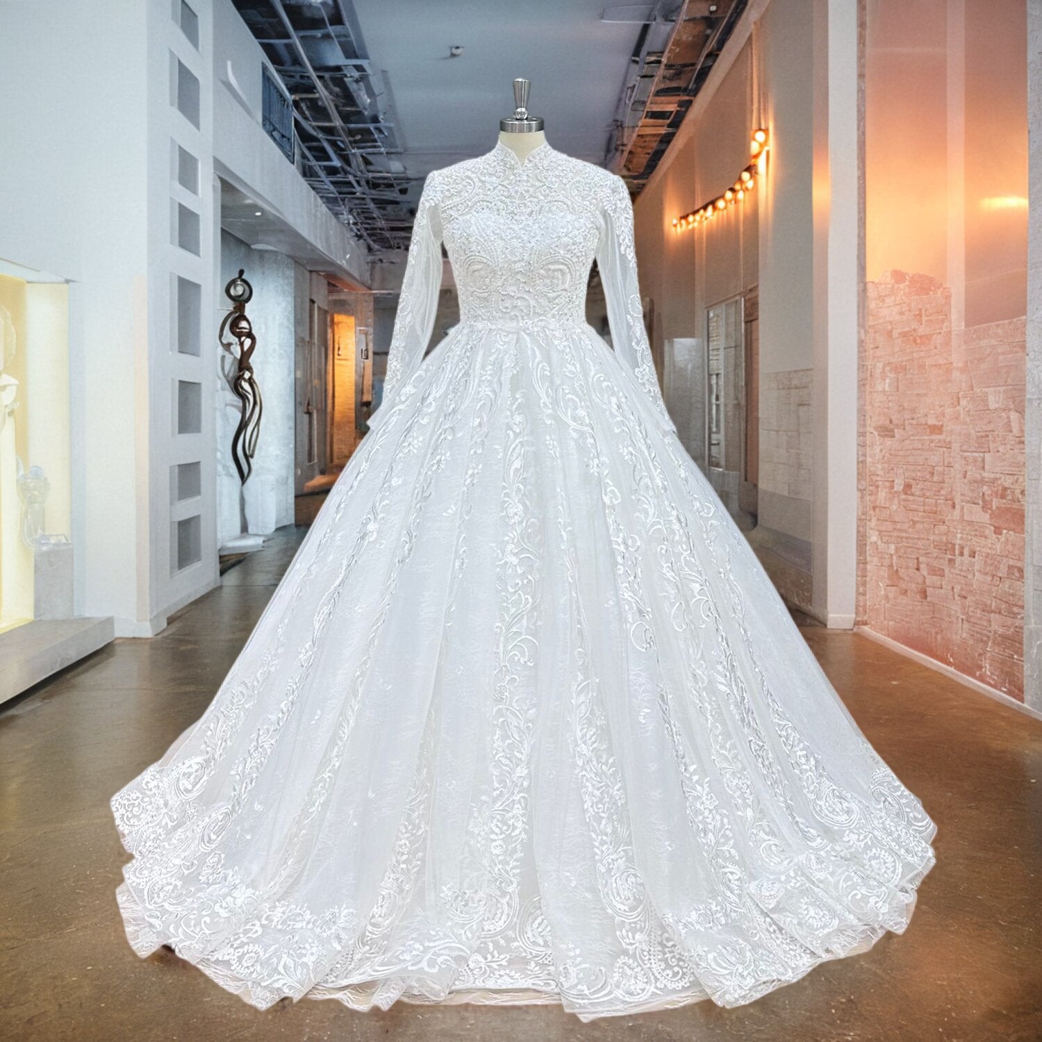 Full front view of a luxury high neck ball gown wedding dress on a mannequin in a bright hallway, highlighting the sheer long sleeves, voluminous tulle skirt, and cascading beaded pearls.