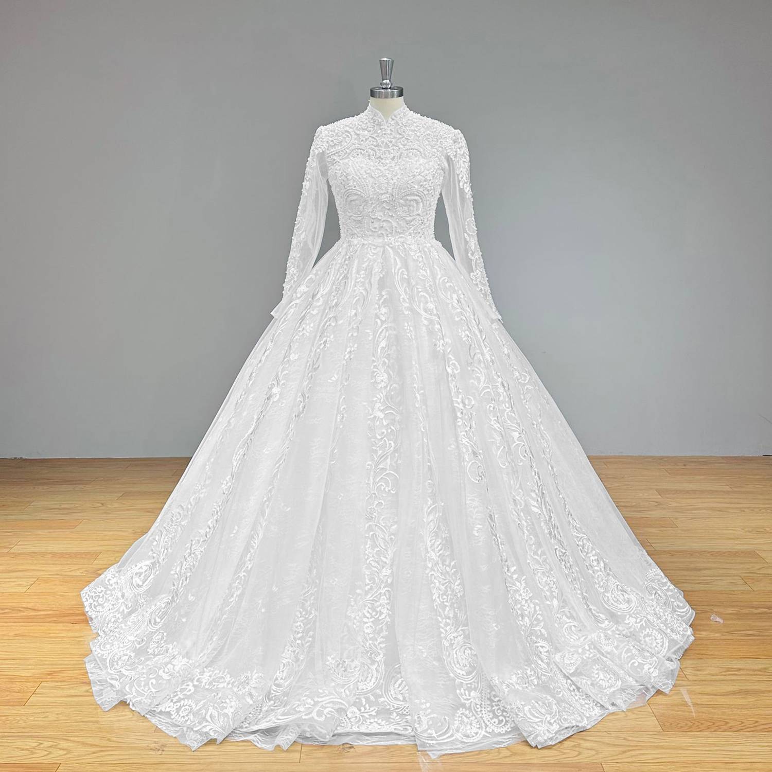 Wide front view of a stunning new beaded pearls long sleeve ball gown wedding dress on a mannequin, perfectly capturing the elegant high neck silhouette and expansive shimmering skirt.