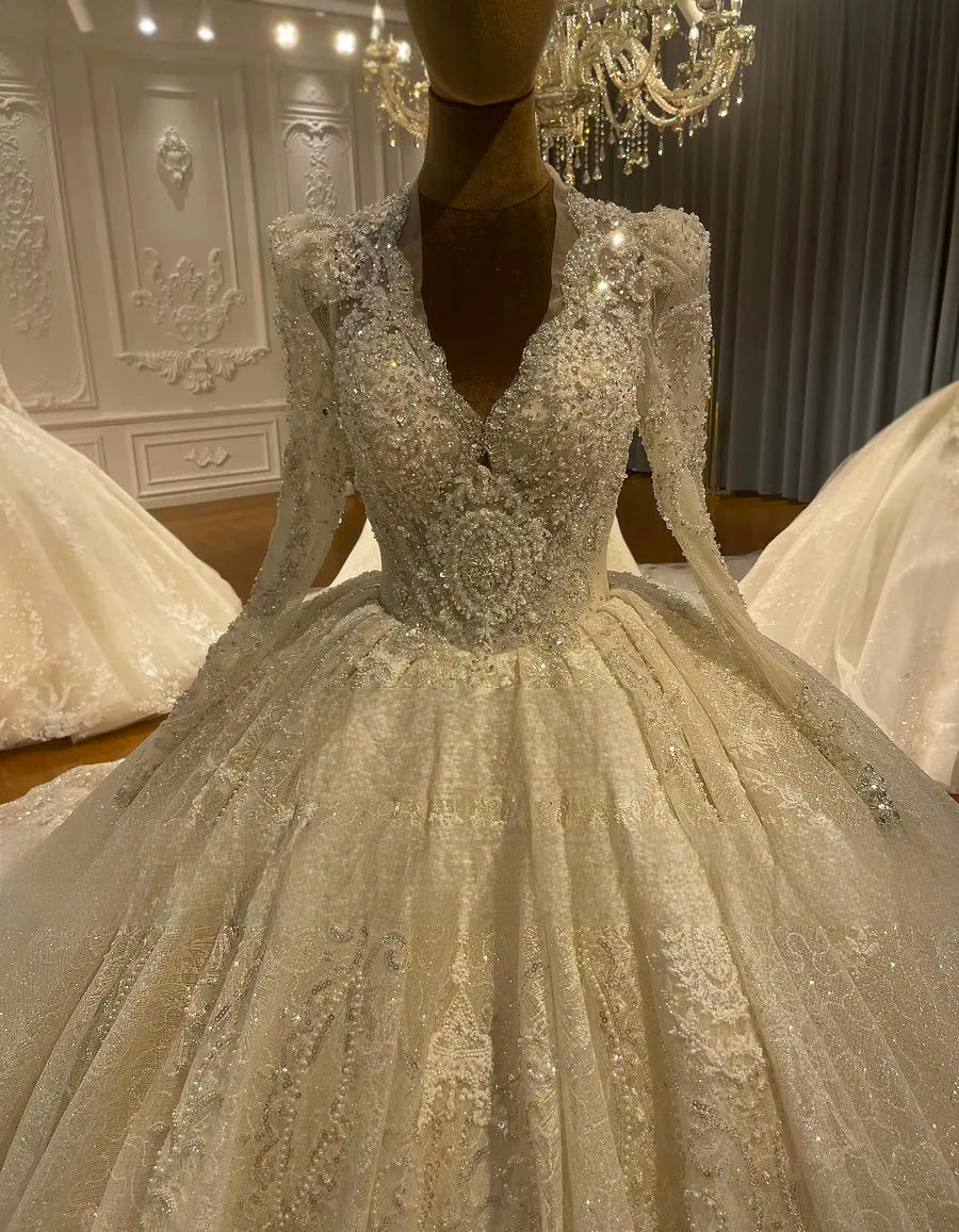 Front view of the elegant heavily beaded bridal ball gown on a mannequin, highlighting the classic deep V-neckline and shimmering full skirt design.