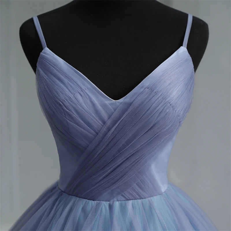 Detailed view of the light blue V-neck bodice, highlighting the intricate pleated tulle texture and delicate spaghetti strap design.