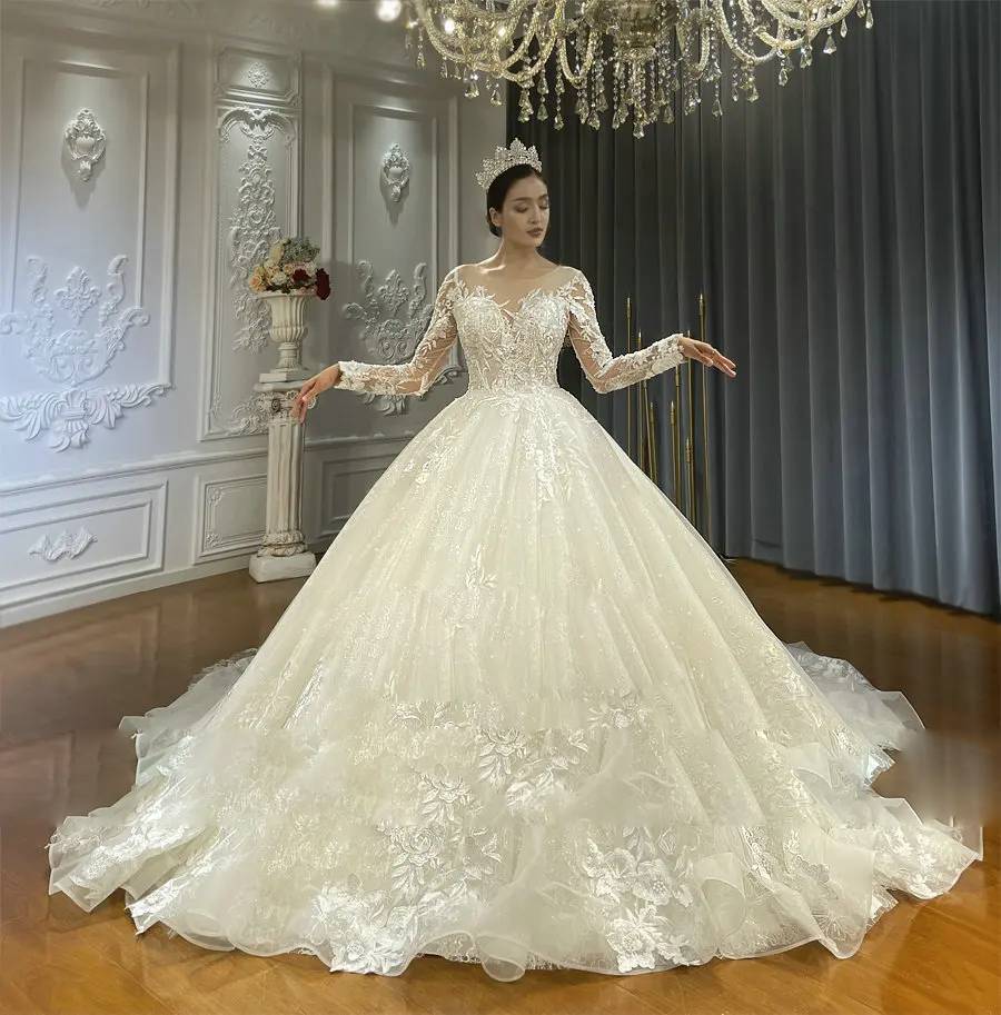 Elegant front pose of a made-to-order A-line bridal dress with a voluminous tulle skirt and a sheer lace-embellished bodice.