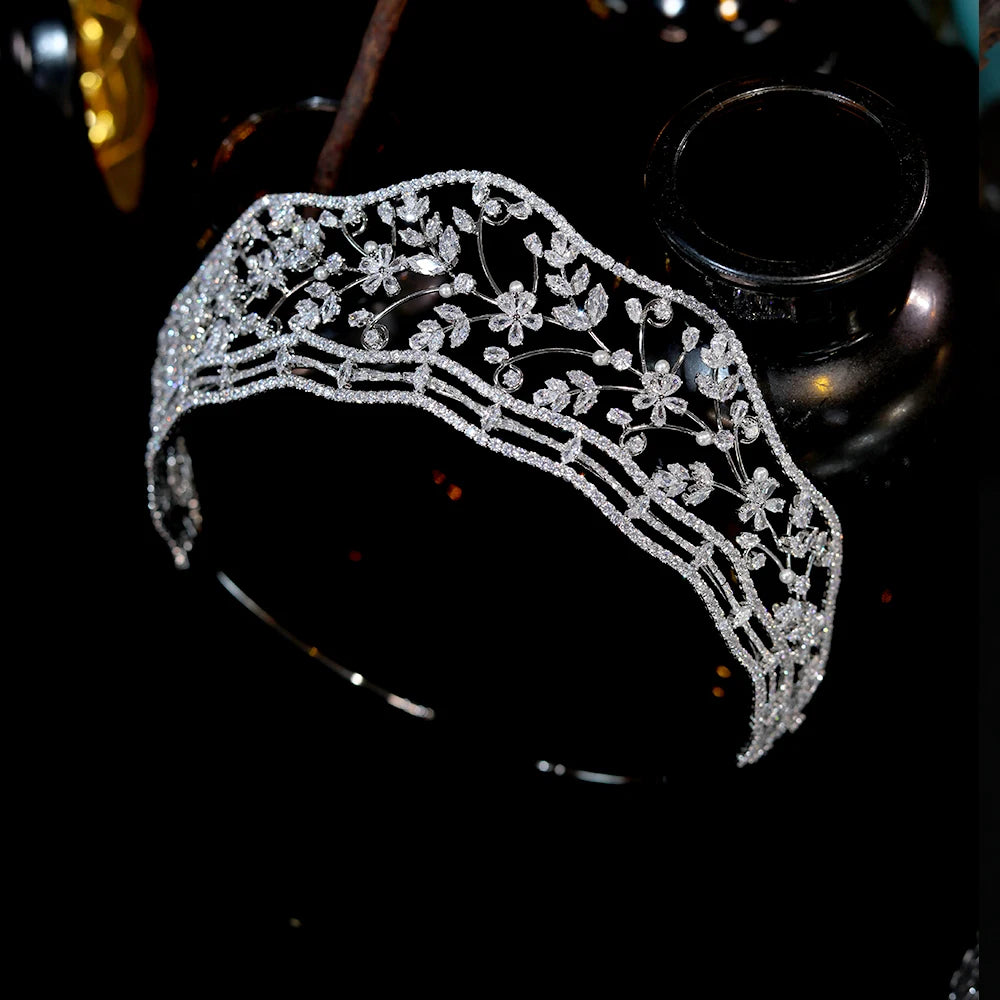High-angle side view showcasing the curved, multi-tiered stone bands and filigree flower branches of the elegant wedding hair jewelry tiara.