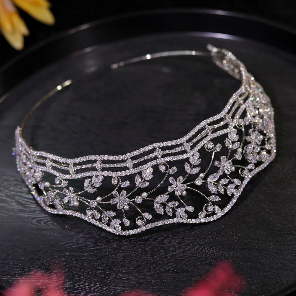 Wide overhead view of the full circular band structure and shimmering micro-pave rhinestone leaf details of the premium wedding crown.