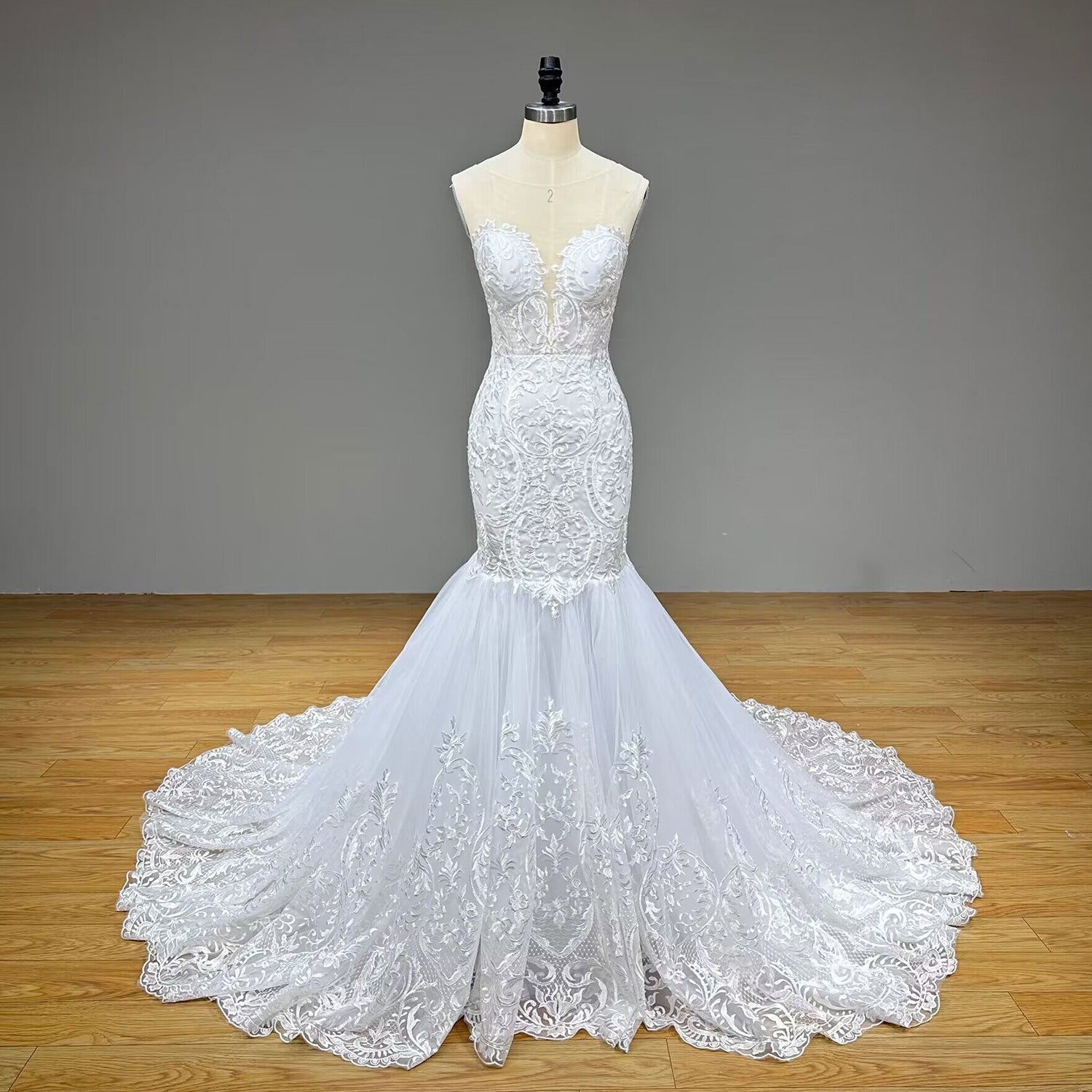 Full-length front studio view of the strapless sweetheart mermaid wedding dress without the shawl, showcasing the form-fitting silhouette and dramatic flared tulle skirt.
