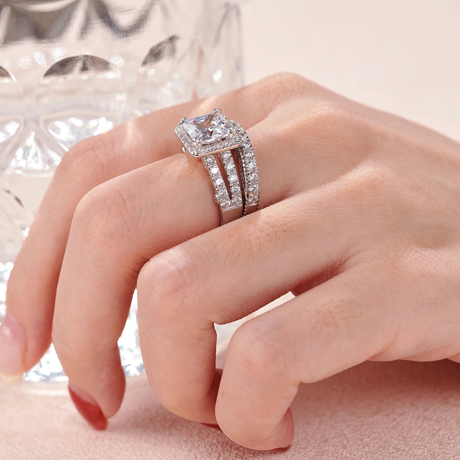 Handheld shot demonstrating the multi-band alignment and side profile of the sparkling split-shank women's engagement ring set.