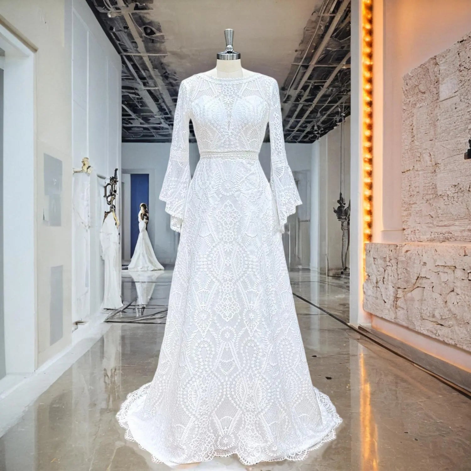 A white A-line lace wedding dress with vintage-inspired flared sleeves and a sheer waist detail displayed on a mannequin in a professional bridal boutique.