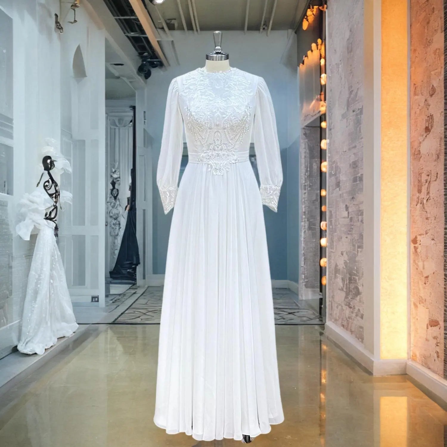 Front view of the O-neck long sleeve chiffon wedding dress displayed on a mannequin, showcasing the delicate floral appliques and flowy A-line chiffon skirt in a showroom setting.