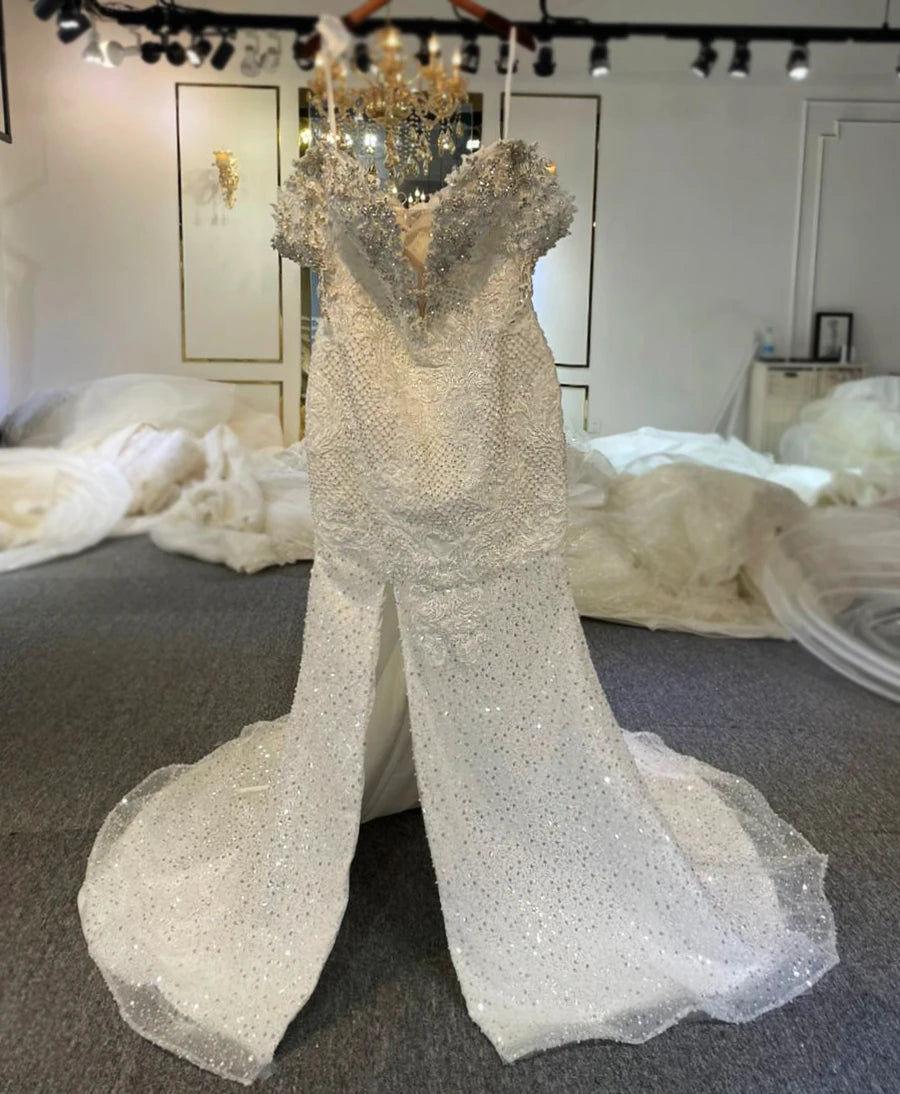 Front perspective of the inner mermaid wedding dress showcasing heavy crystal beading, silver embroidery, and a sophisticated plunging illusion neckline without the removable skirt.