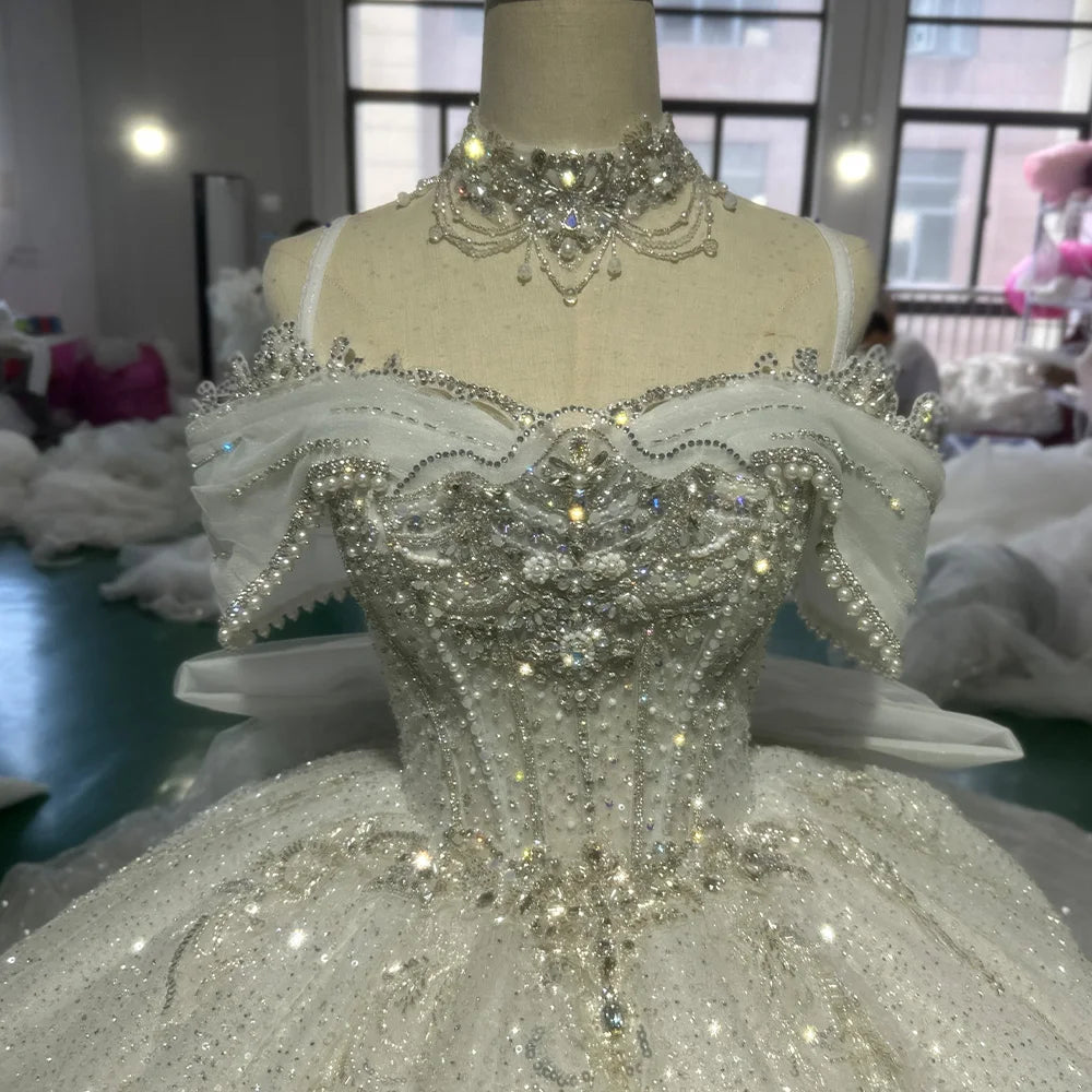 Macro texture view of a luxury princess wedding dress skirt, showcasing premium silver sequin floral patterns and delicate hand-sewn crystal beads on layered tulle.