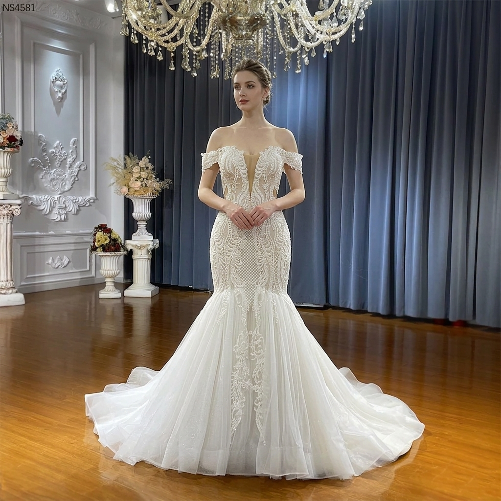 Front view of an elegant off-the-shoulder lace mermaid wedding dress featuring a deep sweetheart neckline, intricate beaded patterns, and a fitted bodice.