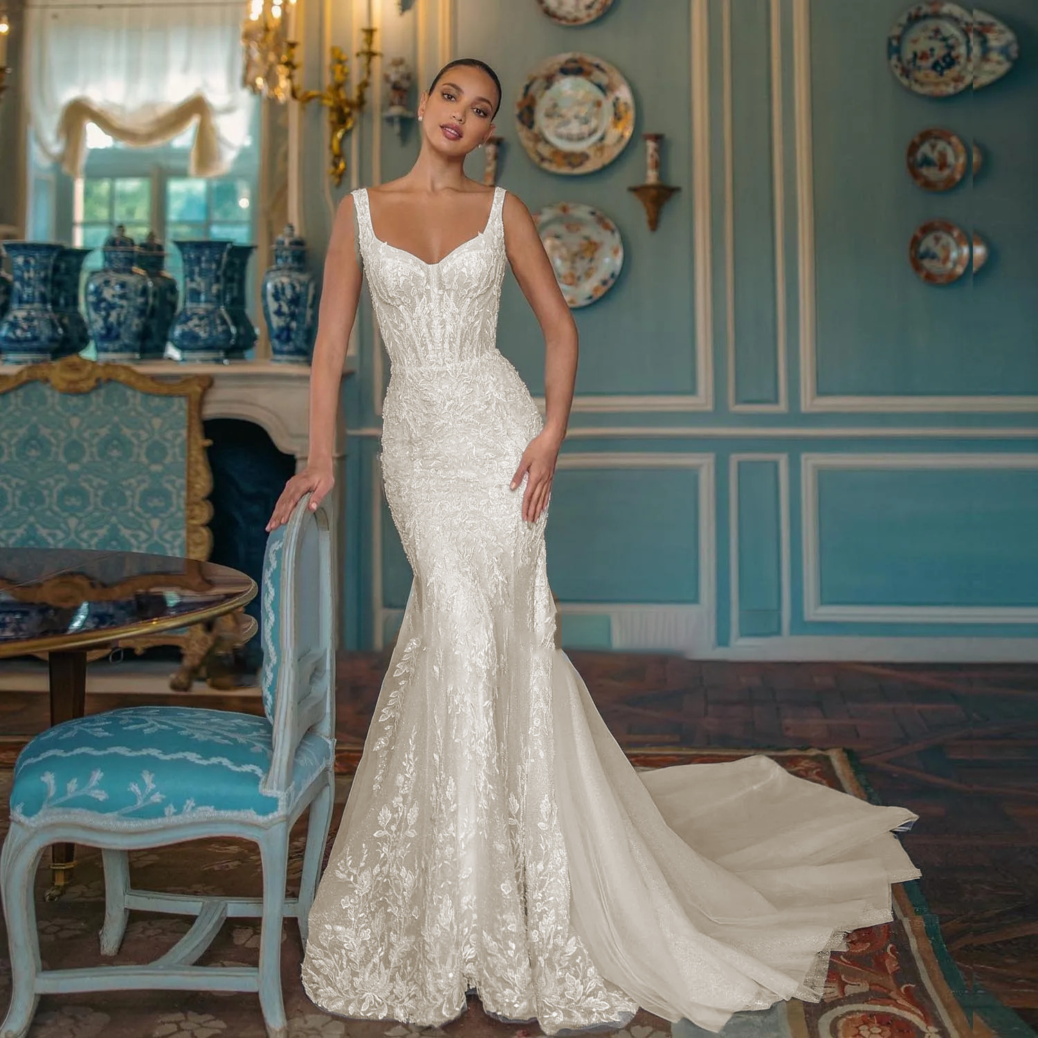 Elegant white beaded mermaid wedding gown with shimmering crystal textures, an illusion sweetheart neckline, and a fitted trumpet skirt flare.