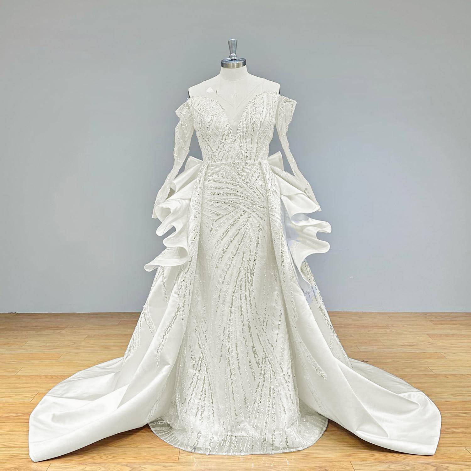 Classic full-length front shot of a formal mermaid bridal gown on a mannequin, highlighting the seamless transition from the beaded bodice to the wide, elegant train.